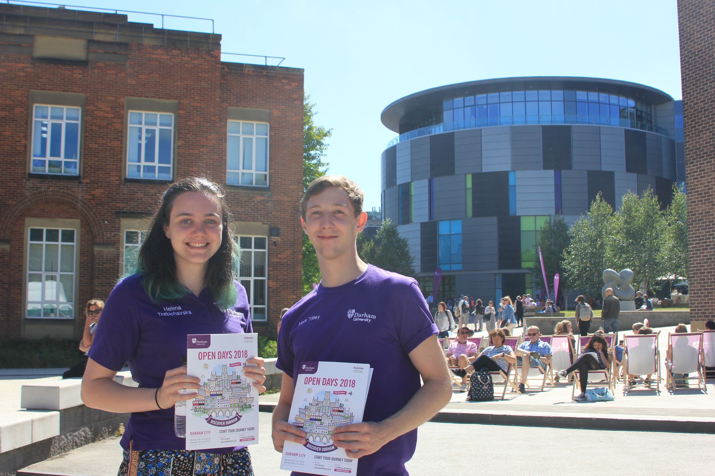 TTwo  students on campus with open day brochures
